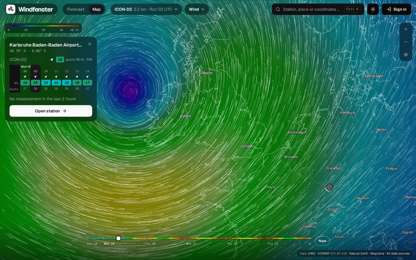 Windfenster's wind map: a low west of Ireland drawn as a colour field with moving particles over Europe, the model chips ICON-D2, ICON global and ECMWF IFS, and a spot card for Karlsruhe Baden-Baden Airport with its coming hours